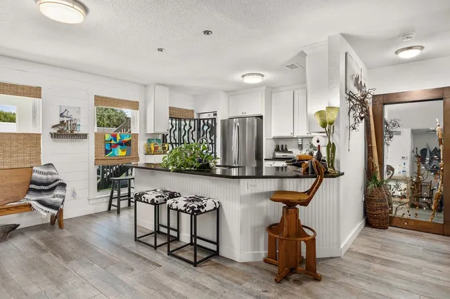 a view of a livingroom with furniture and a gym machine