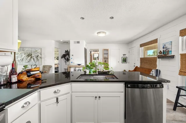 a kitchen with a sink and cabinets