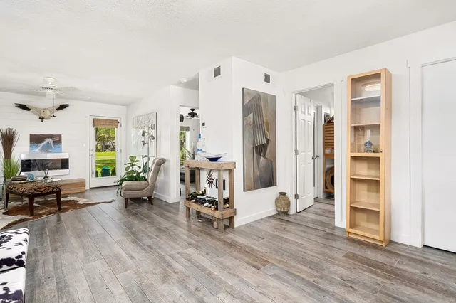 a view of a livingroom with furniture and a flat screen tv