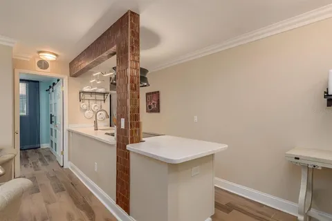 a kitchen with stainless steel appliances granite countertop a refrigerator a stove and a sink with wooden floor