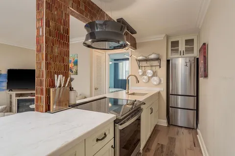 a kitchen with stainless steel appliances granite countertop a refrigerator and a sink