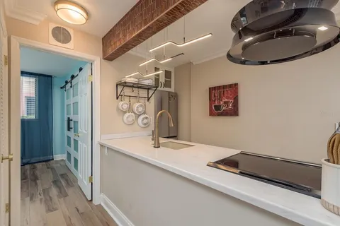 a bedroom with a large bed and wooden floor