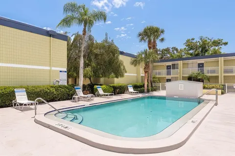 a view of backyard with swimming pool and outdoor seating