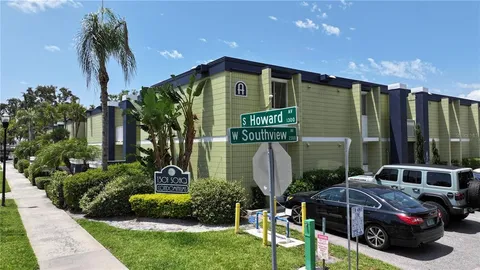 an aerial view of a house with yard swimming pool and outdoor seating