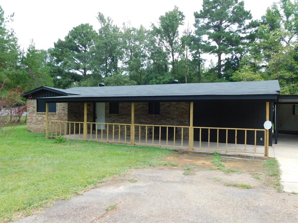 a view of a house with a backyard and porch