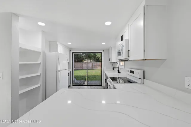 a kitchen with stainless steel appliances a sink and a cabinets