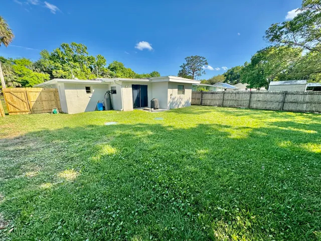 a front view of a house with a yard and a garden