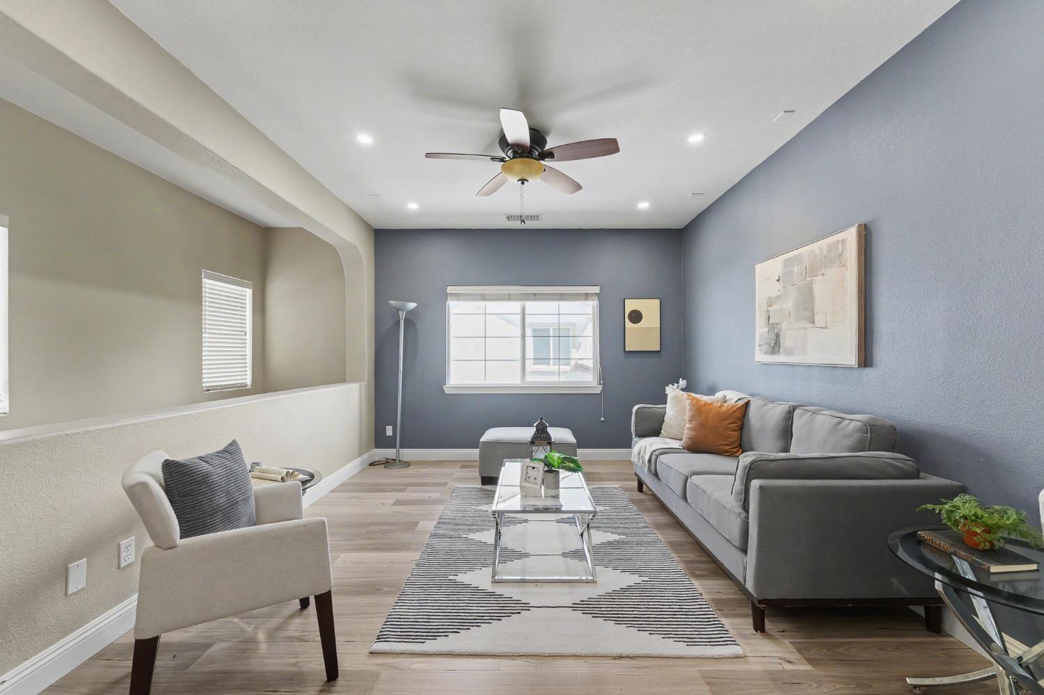1223 East Springer Drive Turlock, CA 95382 - Photo 23 of 48 a living room with furniture and a chandelier
