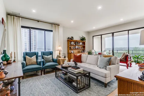 a living room with furniture window and a flat screen tv