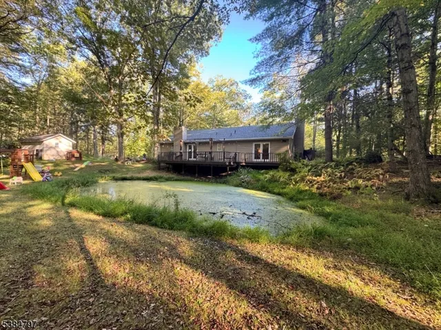 a view of a house with a yard and sitting area