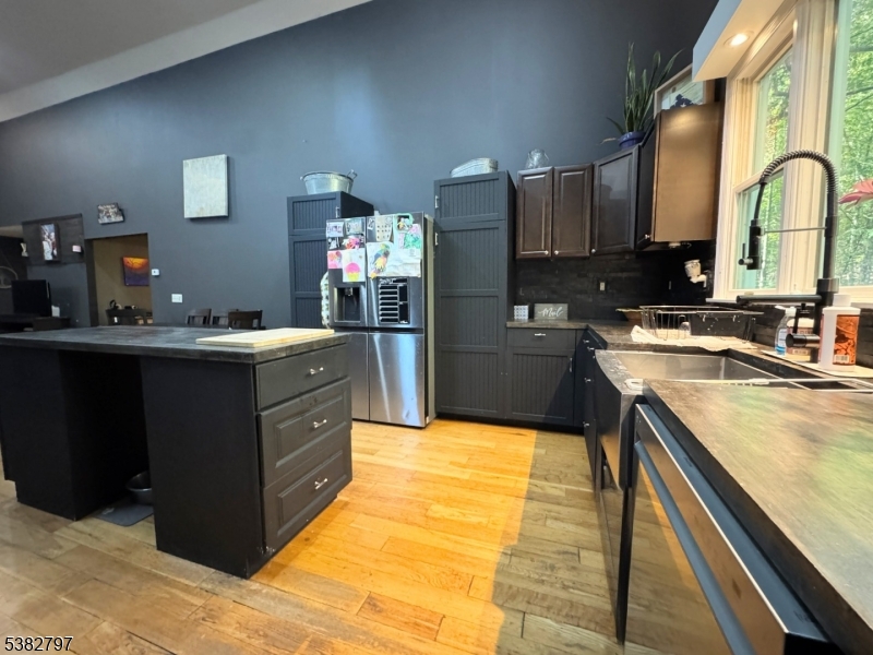 11 Hirams Grove Road Branchville, NJ 07826 - Photo 12 of 50 a kitchen with kitchen island granite countertop a sink stove and cabinets