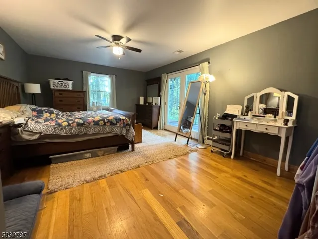 a bed room with a bed furniture and a flat tv screen