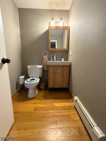 a bathroom with a sink toilet and mirror