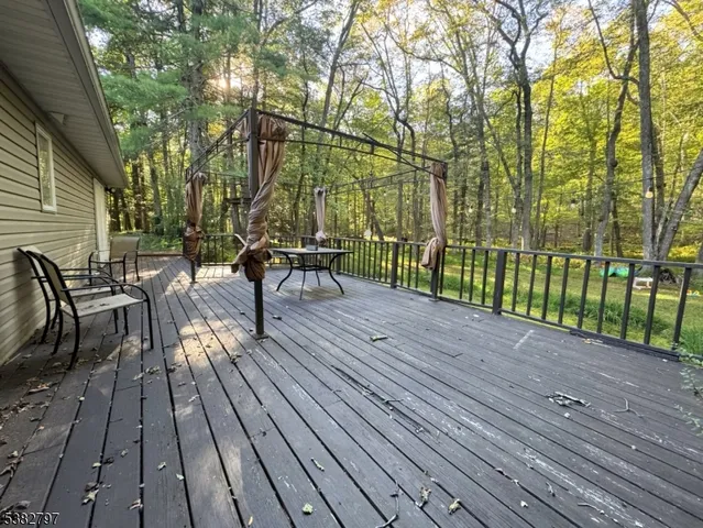 a view of a wooden deck with a yard