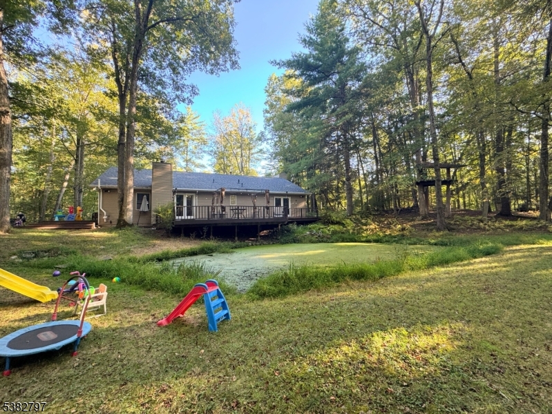 11 Hirams Grove Road Branchville, NJ 07826 - Photo 38 of 50 a view of a backyard with a garden and fire pit