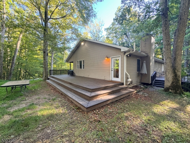 11 Hirams Grove Road Branchville, NJ 07826 - Photo 45 of 50 a view of a house with a yard chairs and a large tree