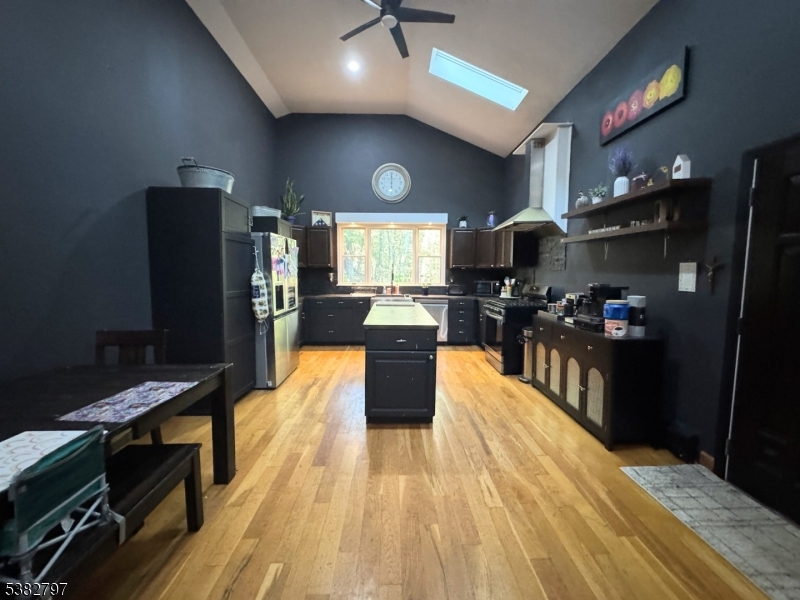 11 Hirams Grove Road Branchville, NJ 07826 - Photo 6 of 50 a kitchen with stainless steel appliances granite countertop a refrigerator a stove top oven and a dining table with wooden floor