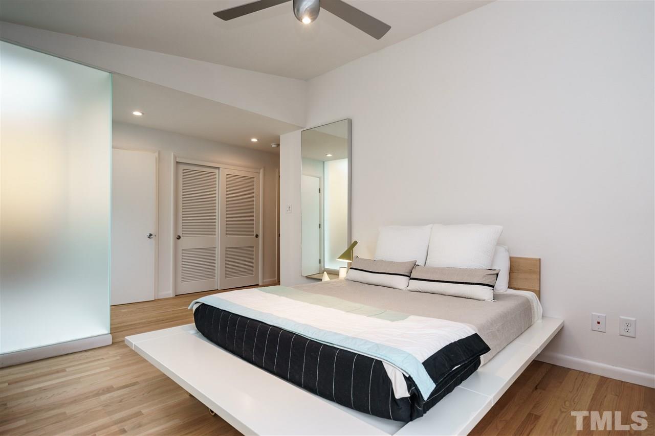 3322 Ocotea Street Raleigh, NC 27607 - Photo 14 of 25 a bedroom with a bed and a night stand