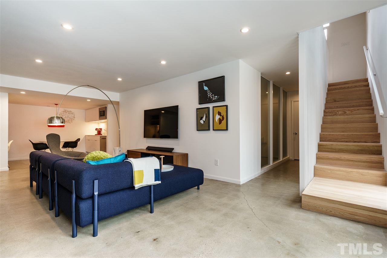 3322 Ocotea Street Raleigh, NC 27607 - Photo 16 of 25 a living room with furniture and a flat screen tv