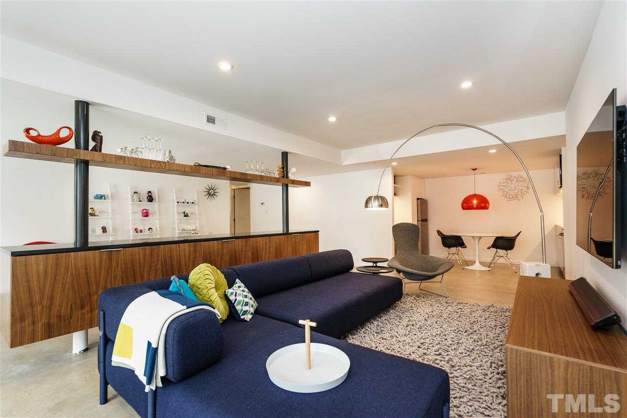 3322 Ocotea Street Raleigh, NC 27607 - Photo 17 of 25 a living room with furniture and a flat screen tv