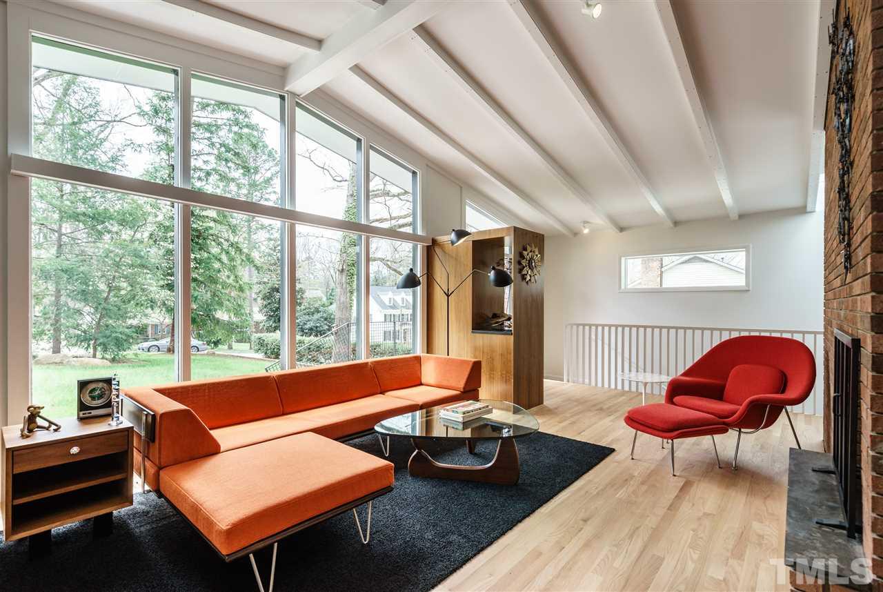 3322 Ocotea Street Raleigh, NC 27607 - Photo 2 of 25 a living room with furniture a rug and a large window