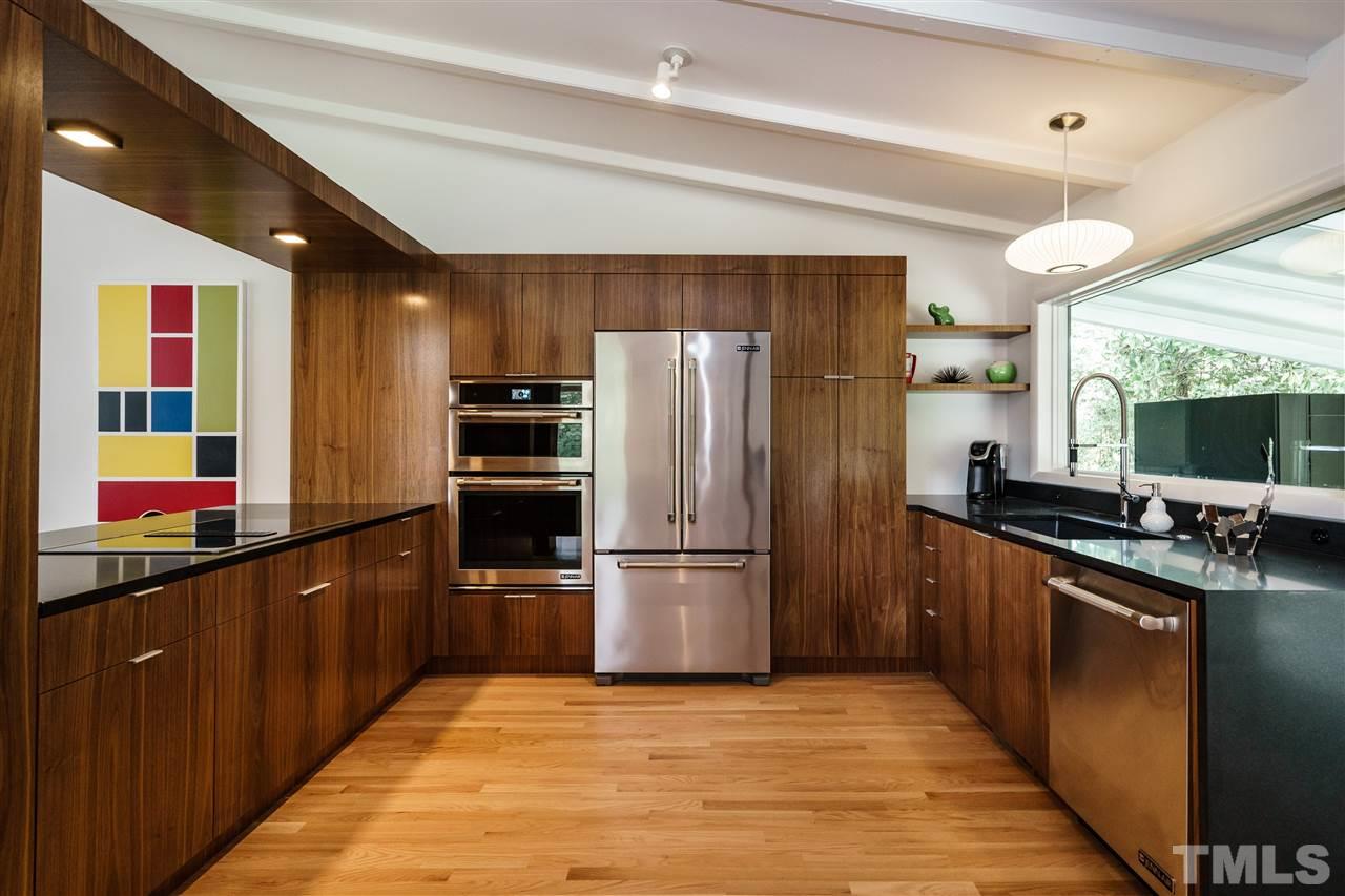 3322 Ocotea Street Raleigh, NC 27607 - Photo 5 of 25 a kitchen with stainless steel appliances granite countertop a refrigerator and a sink