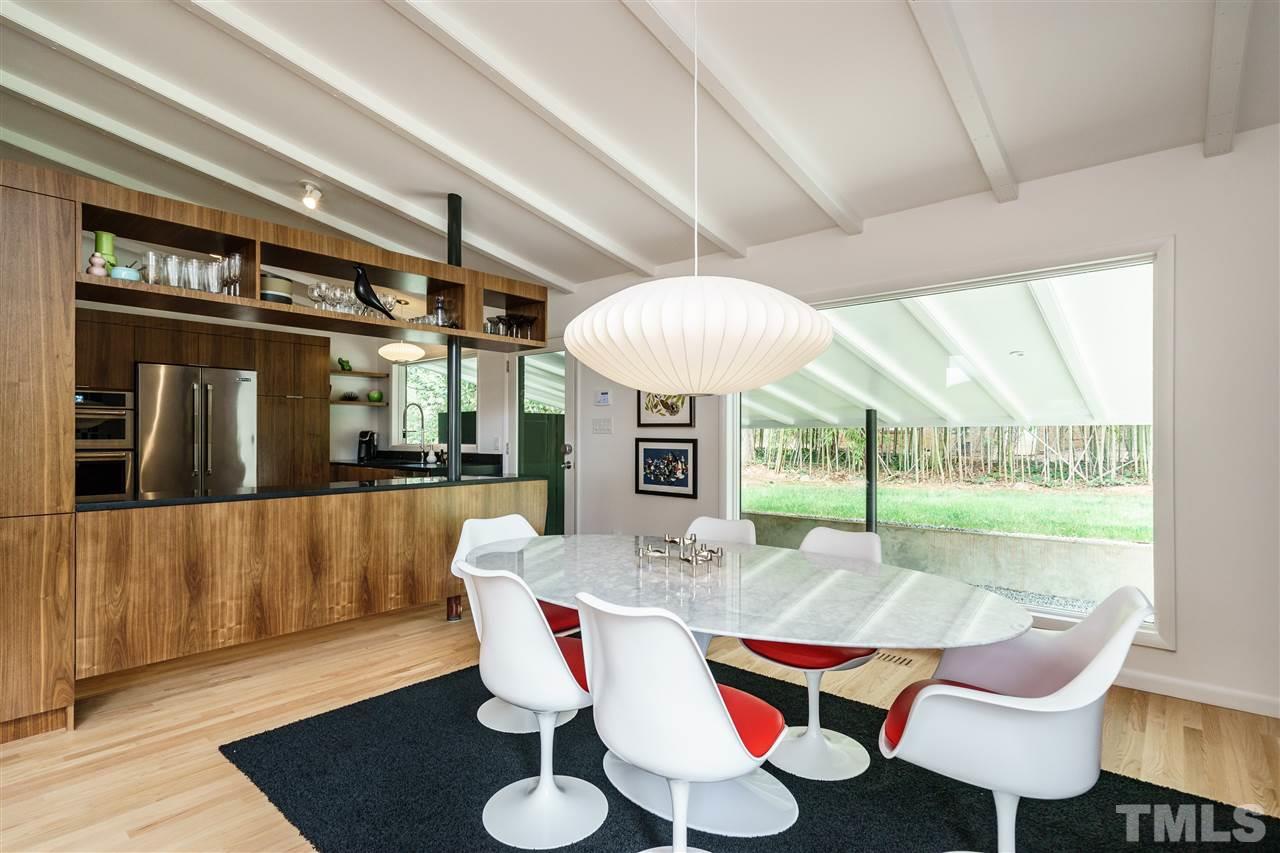 3322 Ocotea Street Raleigh, NC 27607 - Photo 9 of 25 a view of a dining room with furniture wooden floor and chandelier