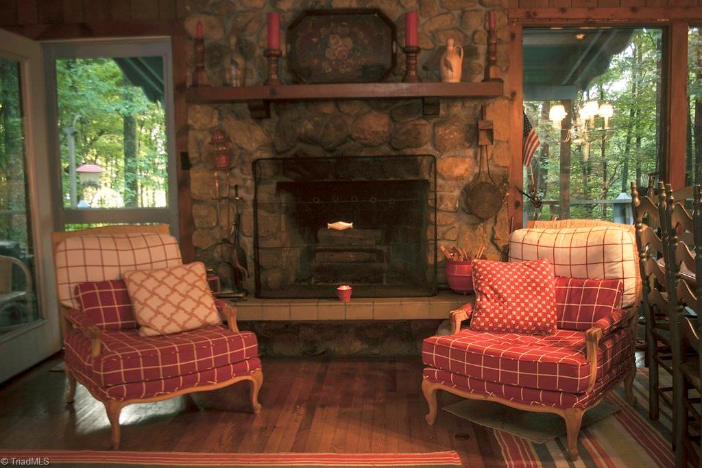 47 Ridge Road Glade Valley, NC 28627 - Photo 3 of 25 Enjoy the warmth of a crackling fire in this beautiful stone fireplace. This home has an open concept great room with a large dining area and living area combined.
