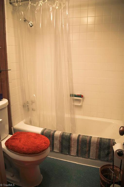 47 Ridge Road Glade Valley, NC 28627 - Photo 21 of 25 The lower level bathroom has a full sized tub shower. There is a full bath on each level of this home.