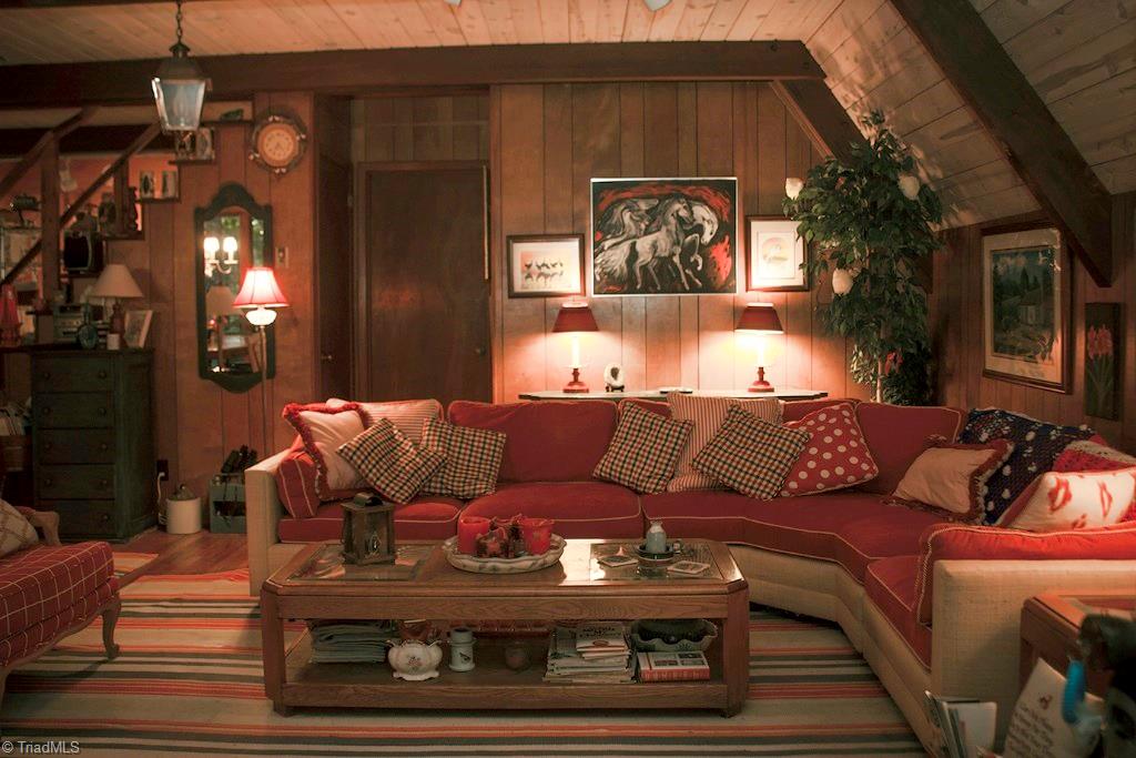 47 Ridge Road Glade Valley, NC 28627 - Photo 9 of 25 The living area features charming A frame walls, wood floors beneath the area rugs, and lots of room for family and friends. The furniture is negotiable and can convey to the buyer with an accepted offer.