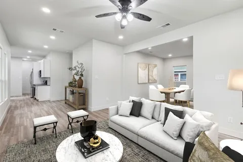 a living room with furniture and a chandelier