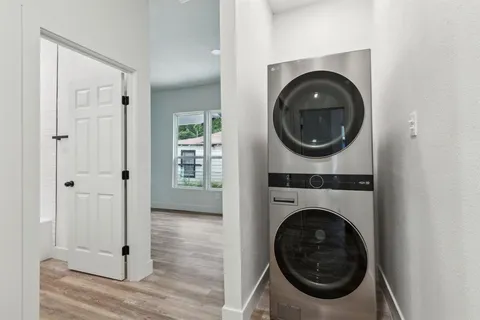 a view of a hallway with washer and dryer