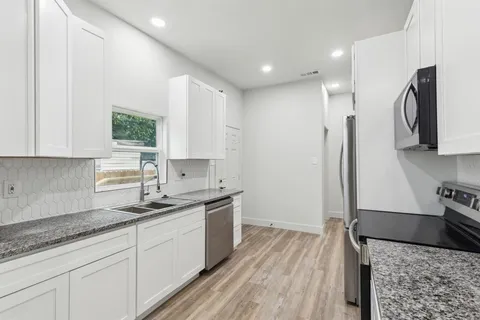 a kitchen with a sink stove and refrigerator