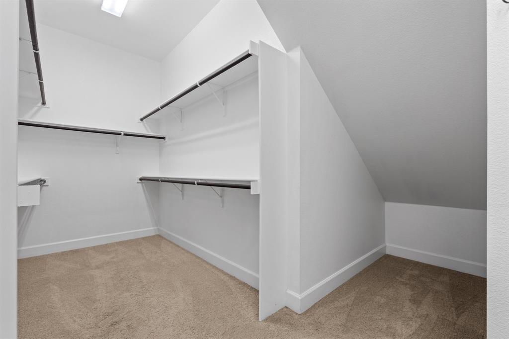 2812 Orchid Street Carrollton, TX 75007 - Photo 24 of 39 Spacious closet with light colored carpet and vaulted ceiling