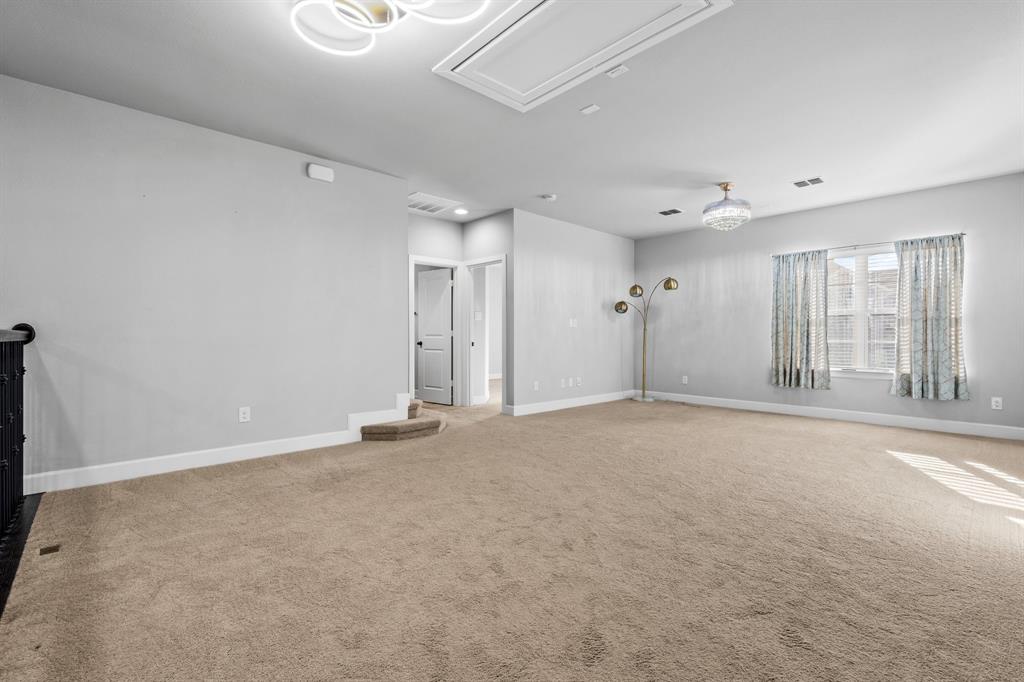 2812 Orchid Street Carrollton, TX 75007 - Photo 27 of 39 Unfurnished room featuring light colored carpet and attic access