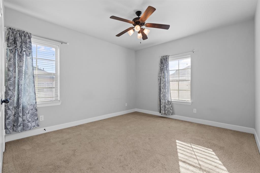 2812 Orchid Street Carrollton, TX 75007 - Photo 30 of 39 Empty room featuring light colored carpet and a ceiling fan