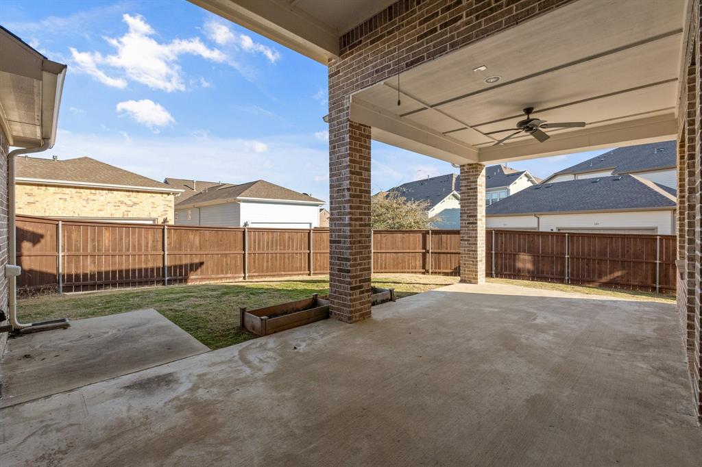 2812 Orchid Street Carrollton, TX 75007 - Photo 33 of 39 Fenced backyard featuring a patio area, ceiling fan, and a residential view