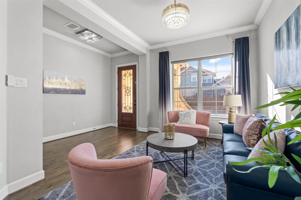 2812 Orchid Street Carrollton, TX 75007 - Photo 7 of 39 Living area with crown molding, dark wood-style floors, and a chandelier