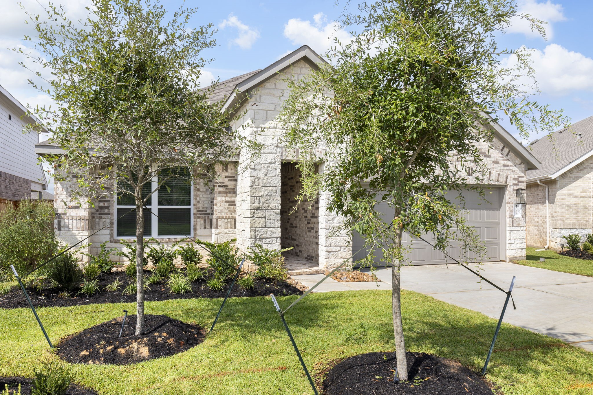 1589 Oakdale Crest Road Montgomery, TX 77316 - Photo 2 of 33 Two growing oak trees in the front yard with full sprinkler system front and back.