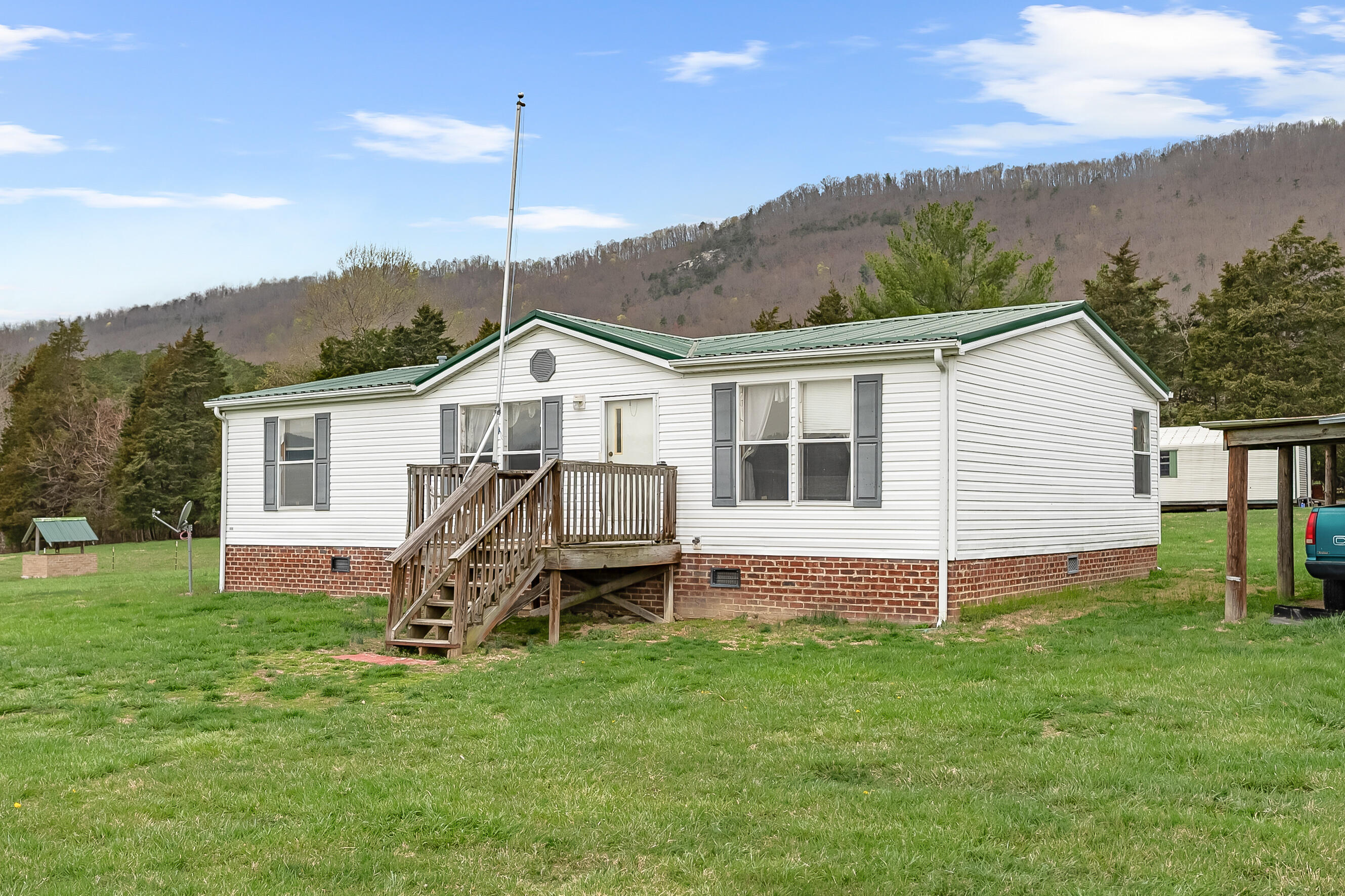 3588 Flatwoods Road Elliston, VA 24087 - Photo 1 of 119 a view of a house with a backyard and a tree