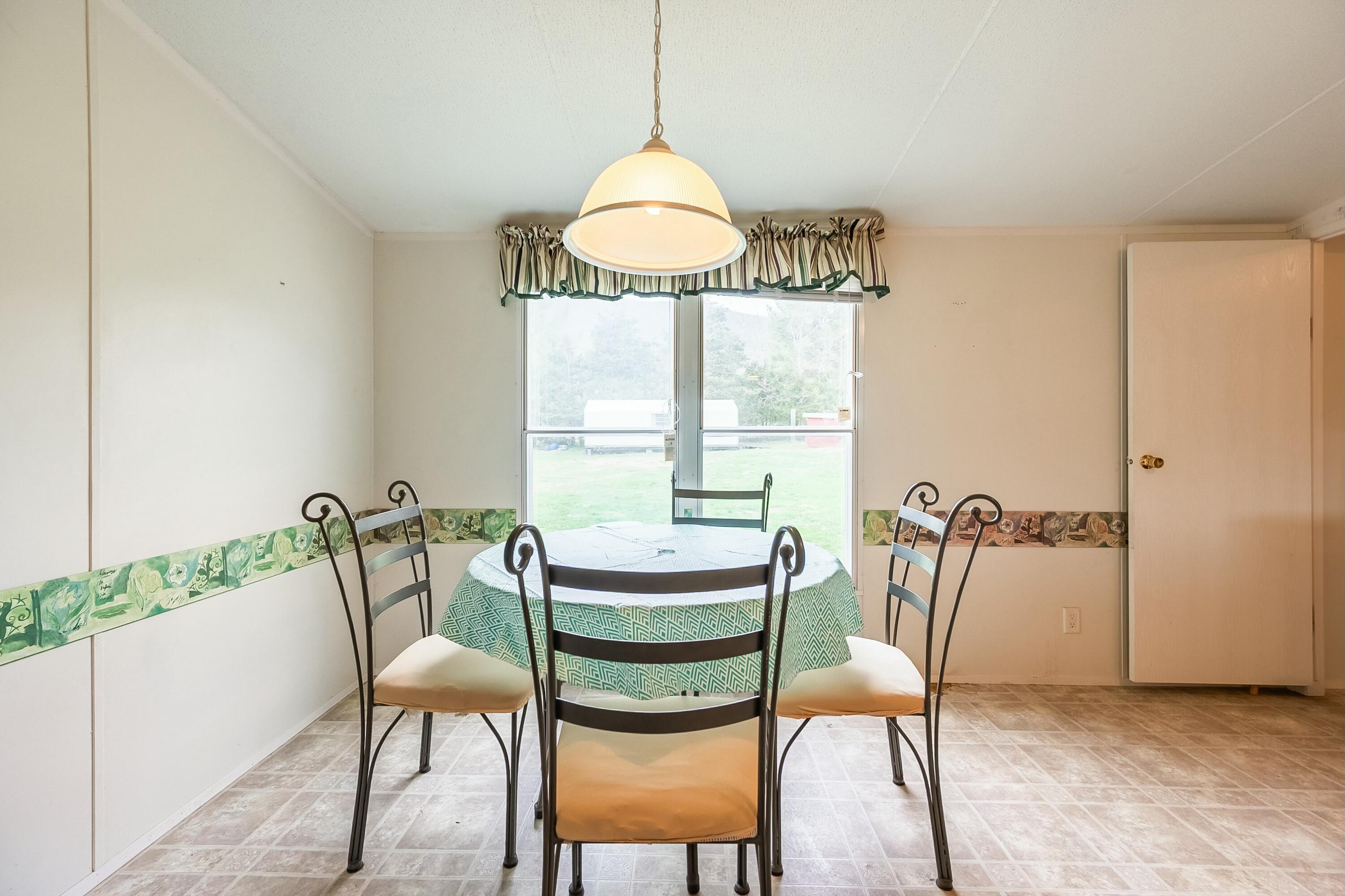 3588 Flatwoods Road Elliston, VA 24087 - Photo 15 of 119 a dining room with furniture and window