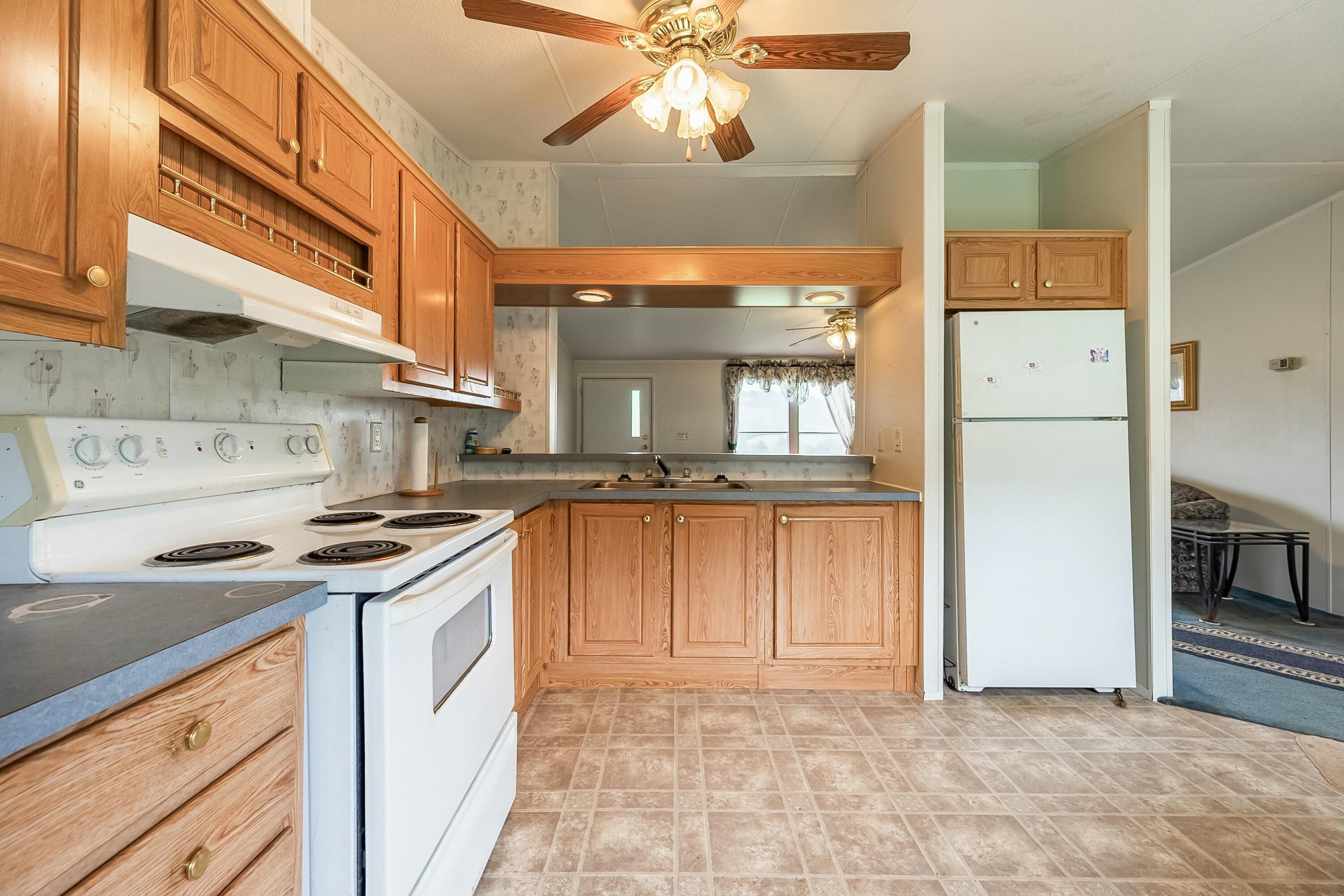 3588 Flatwoods Road Elliston, VA 24087 - Photo 19 of 119 a kitchen with a stove a refrigerator and a sink