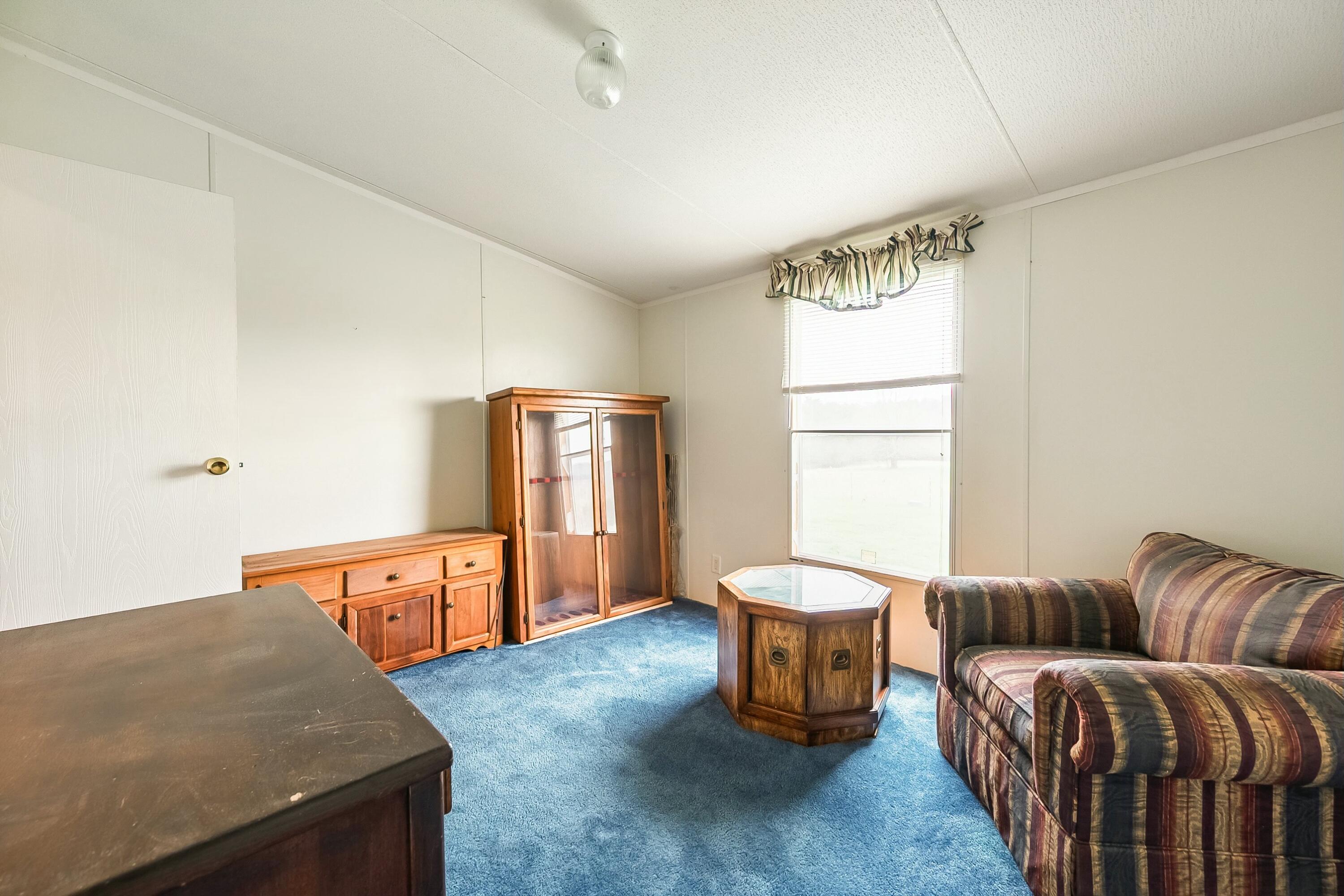 3588 Flatwoods Road Elliston, VA 24087 - Photo 27 of 119 a living room with a couch and a window