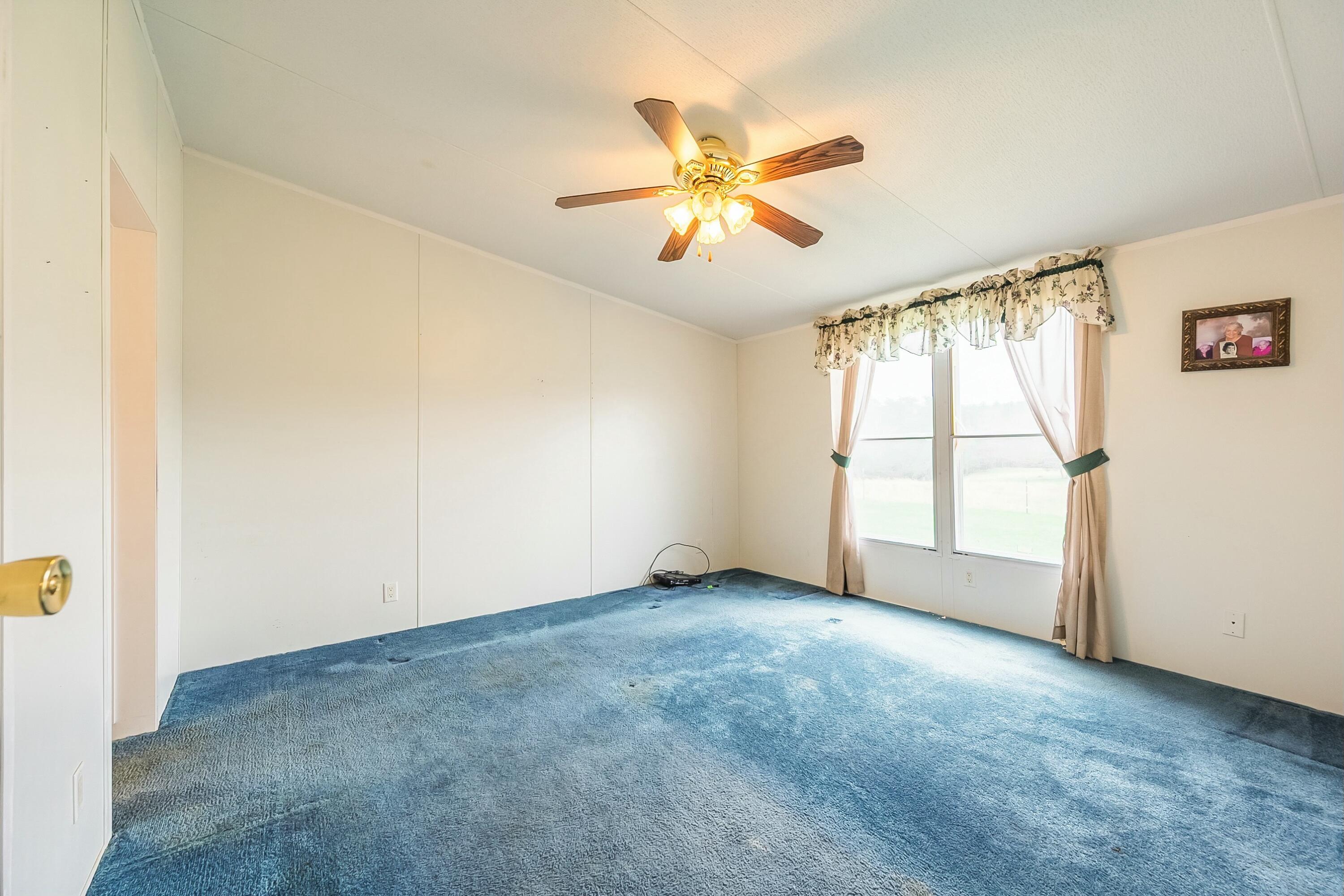 3588 Flatwoods Road Elliston, VA 24087 - Photo 33 of 119 an empty room with windows and fan
