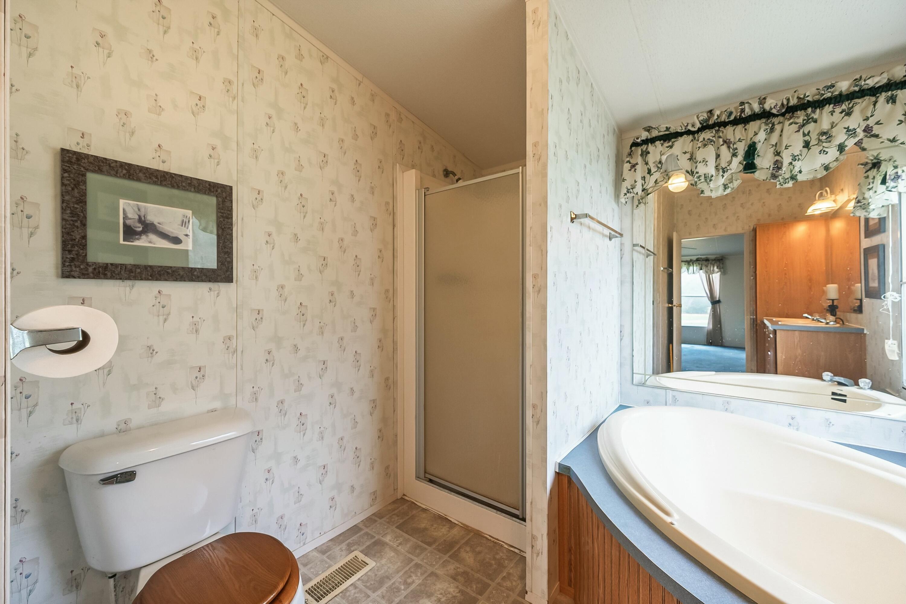 3588 Flatwoods Road Elliston, VA 24087 - Photo 41 of 119 a bathroom with a sink a toilet and shower curtain