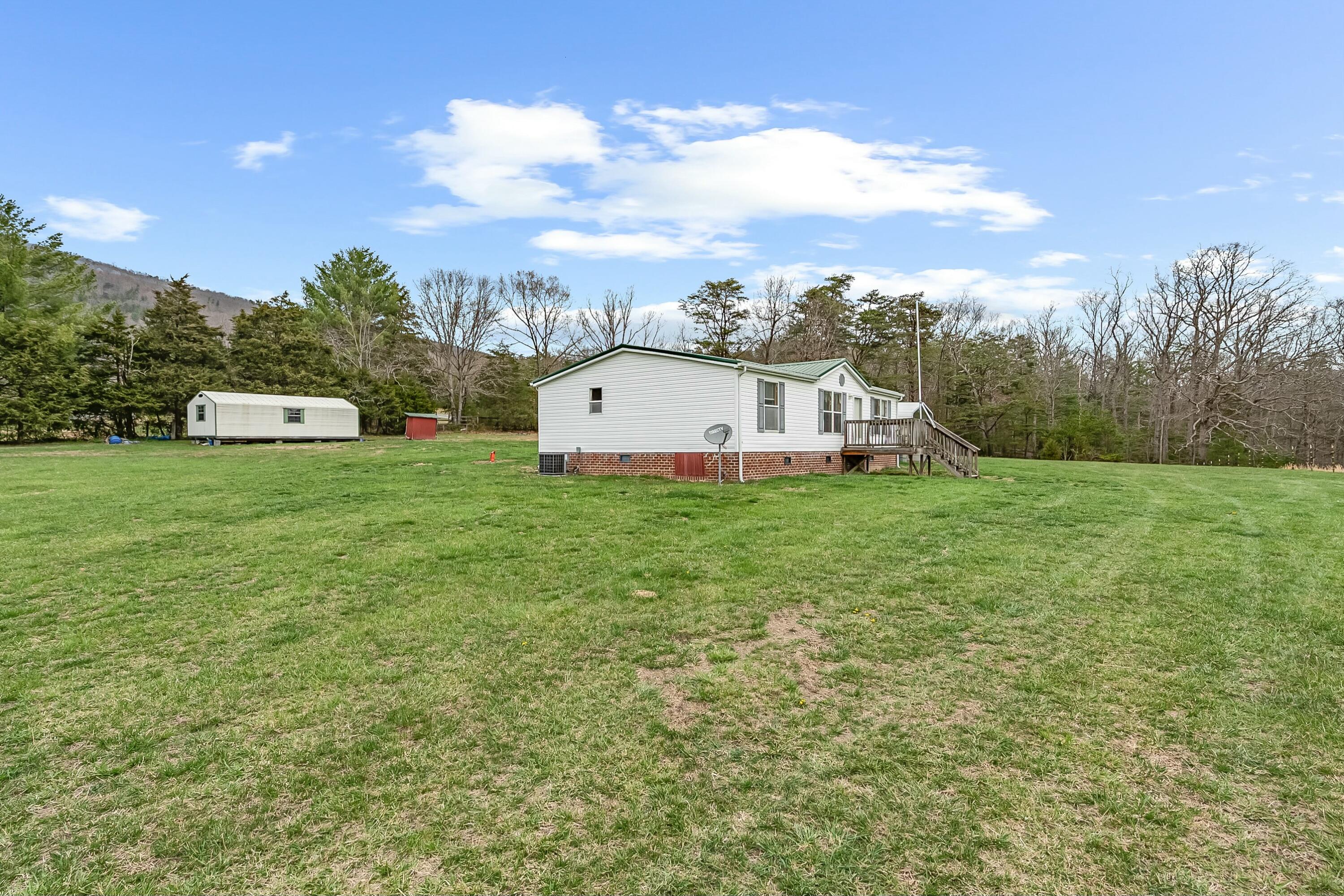 3588 Flatwoods Road Elliston, VA 24087 - Photo 81 of 119 a view of a house with a yard and sitting area