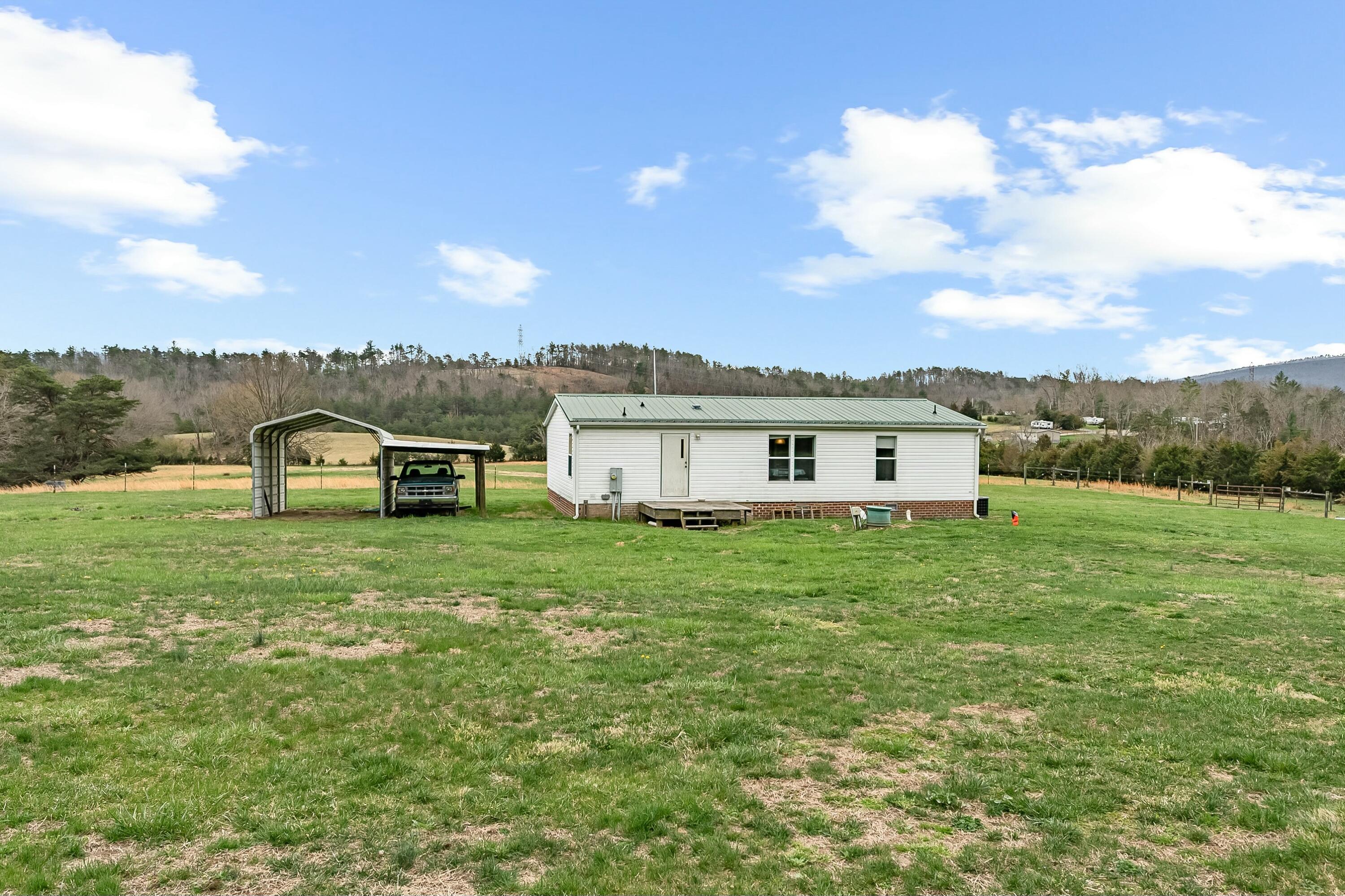 3588 Flatwoods Road Elliston, VA 24087 - Photo 87 of 119 a view of a big house with a big yard and large tree