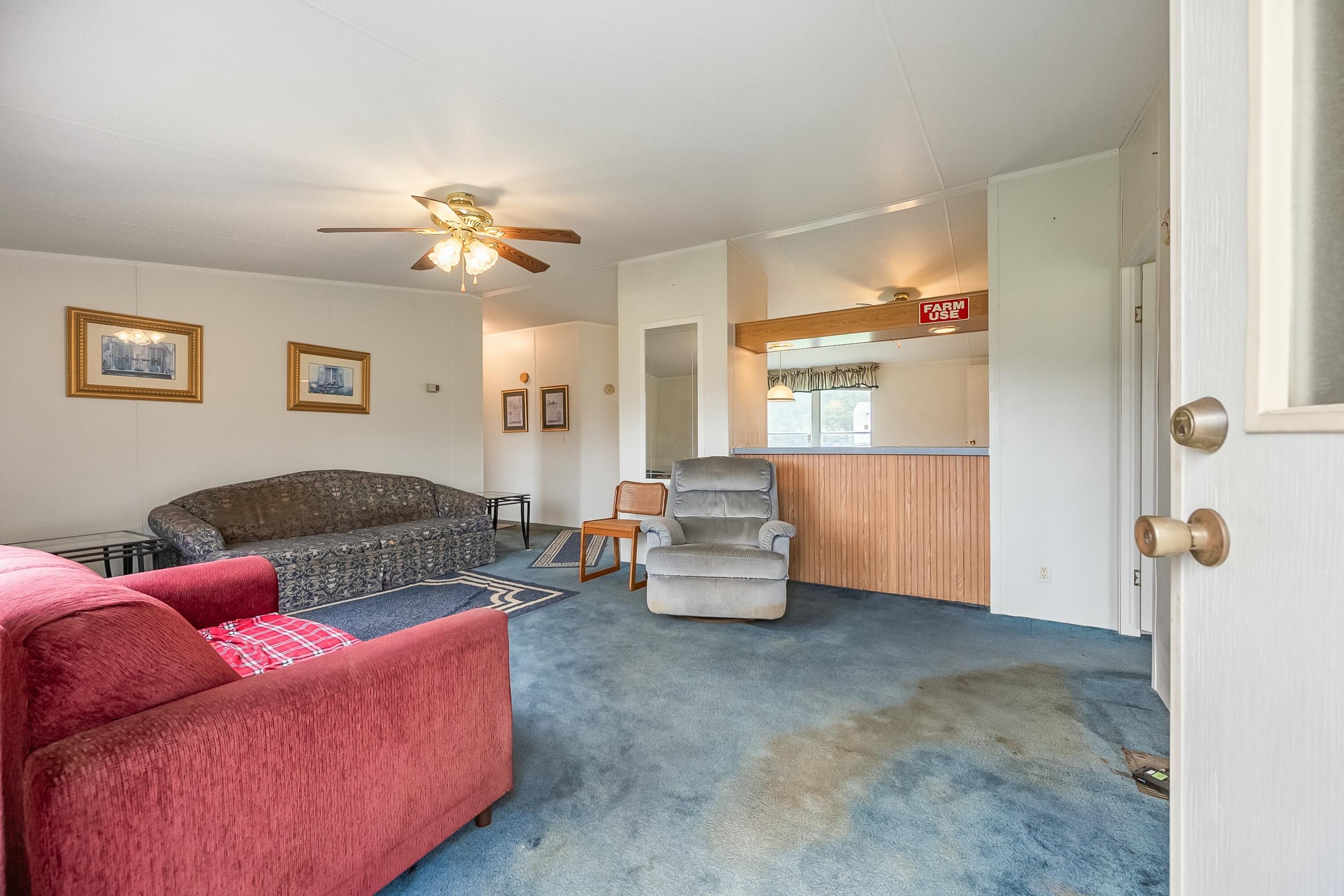 3588 Flatwoods Road Elliston, VA 24087 - Photo 10 of 119 a living room with furniture and a chandelier
