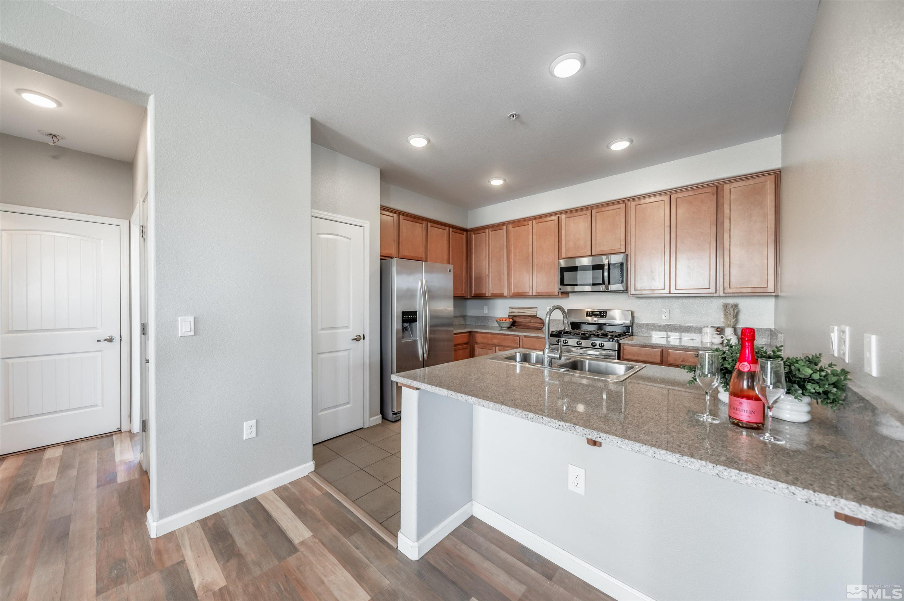 2490 Eastshore Place, Unit 602 Reno, NV 89509 - Photo 16 of 36 a kitchen with sink a refrigerator and cabinets