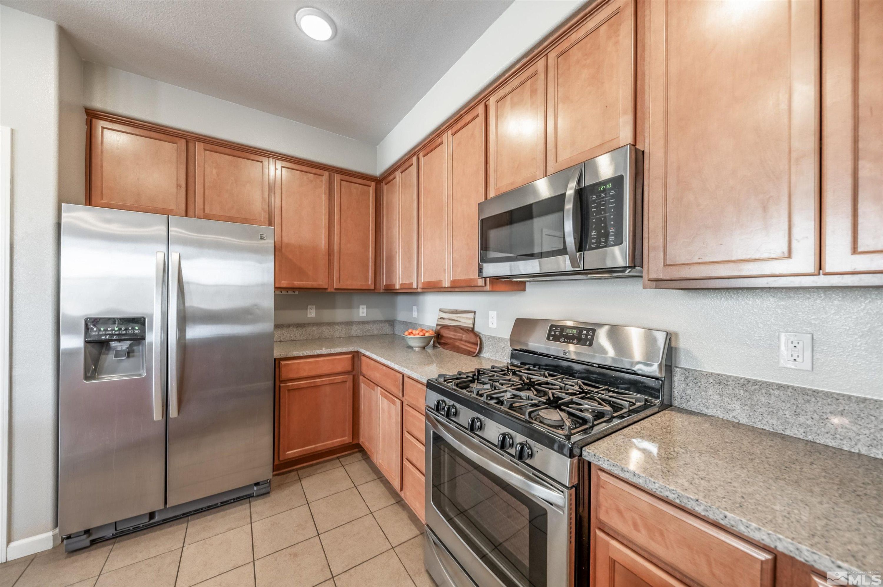 2490 Eastshore Place, Unit 602 Reno, NV 89509 - Photo 17 of 36 a kitchen with stainless steel appliances granite countertop a refrigerator stove top oven and sink
